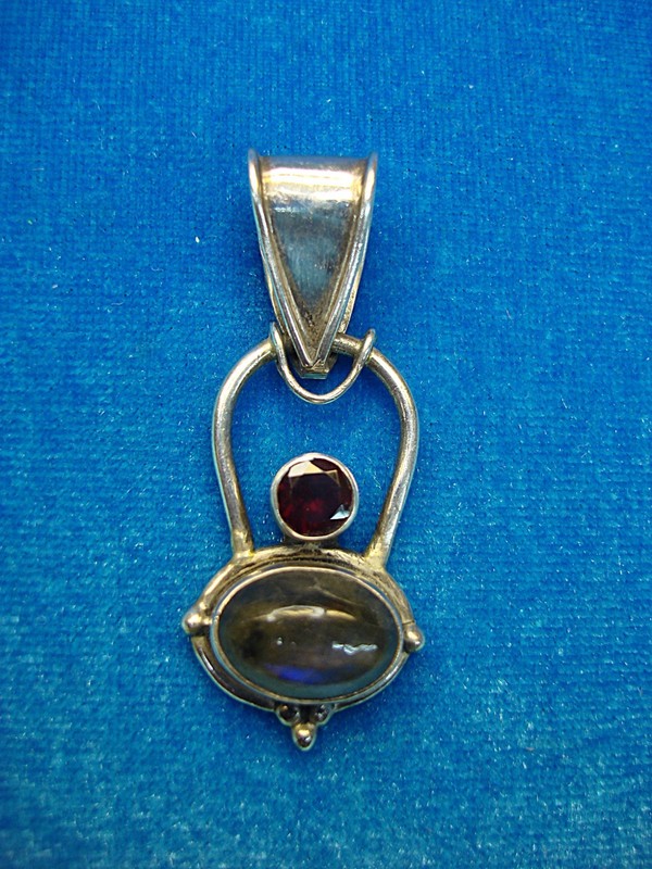 Sterling silver pendant with oval quartz and red stone