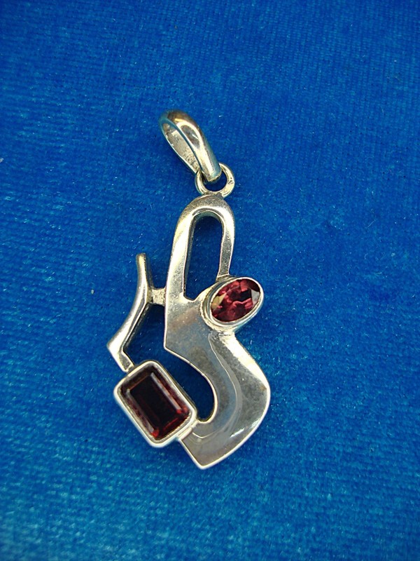 Modernist sterling silver pendant with red stone accents