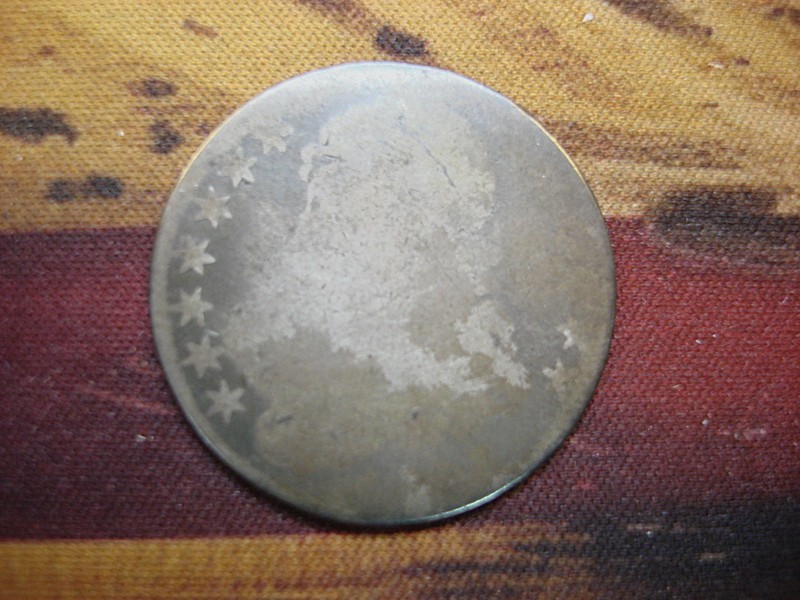 Antique US Bust Half Dollar coin from the 1800s with a worn date
