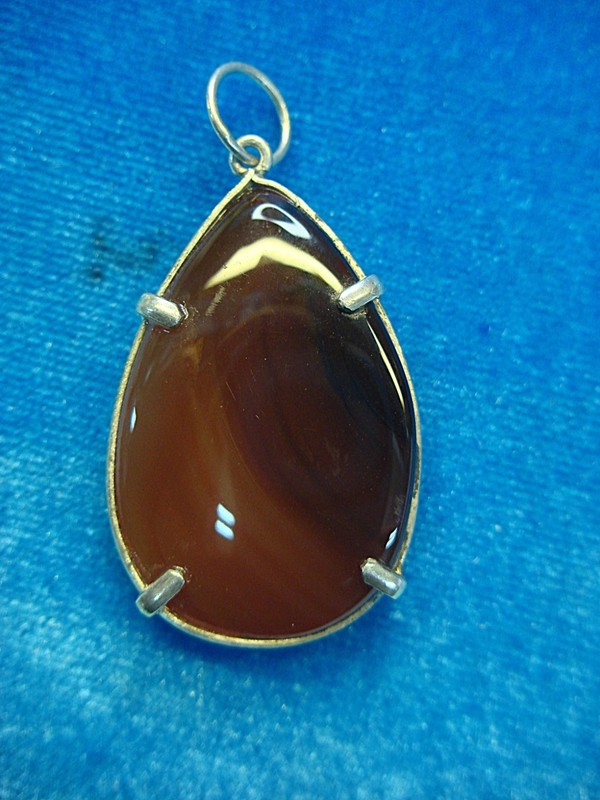 Handmade sterling silver carnelian pendant with a prong-set center stone