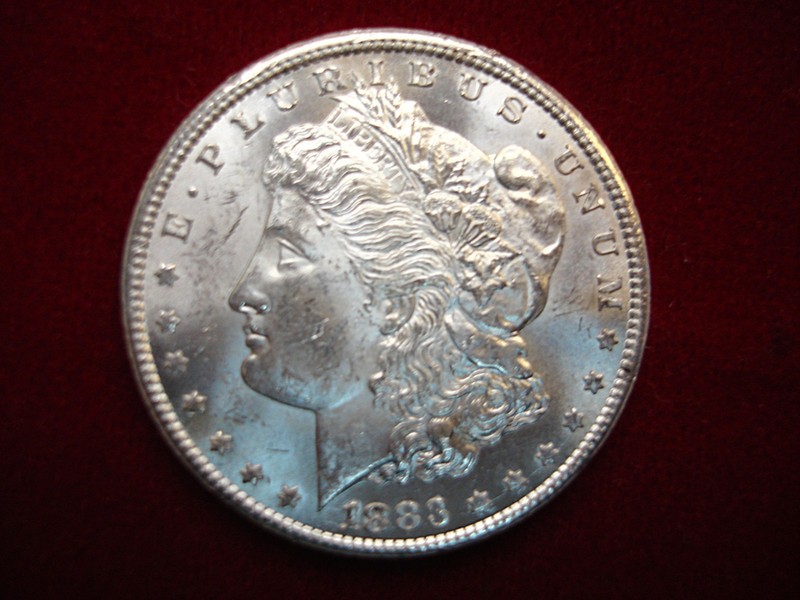 1883 CC Morgan Dollar, uncirculated with frostiness, rare date