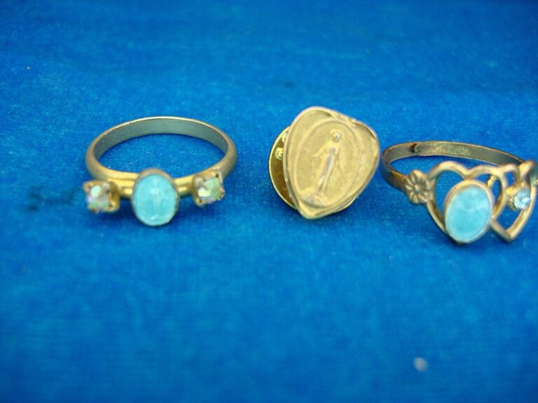 Vintage gold-tone Miraculous Mary ring set with two rings (sizes 5 and 5 1/2) and a lapel pin.