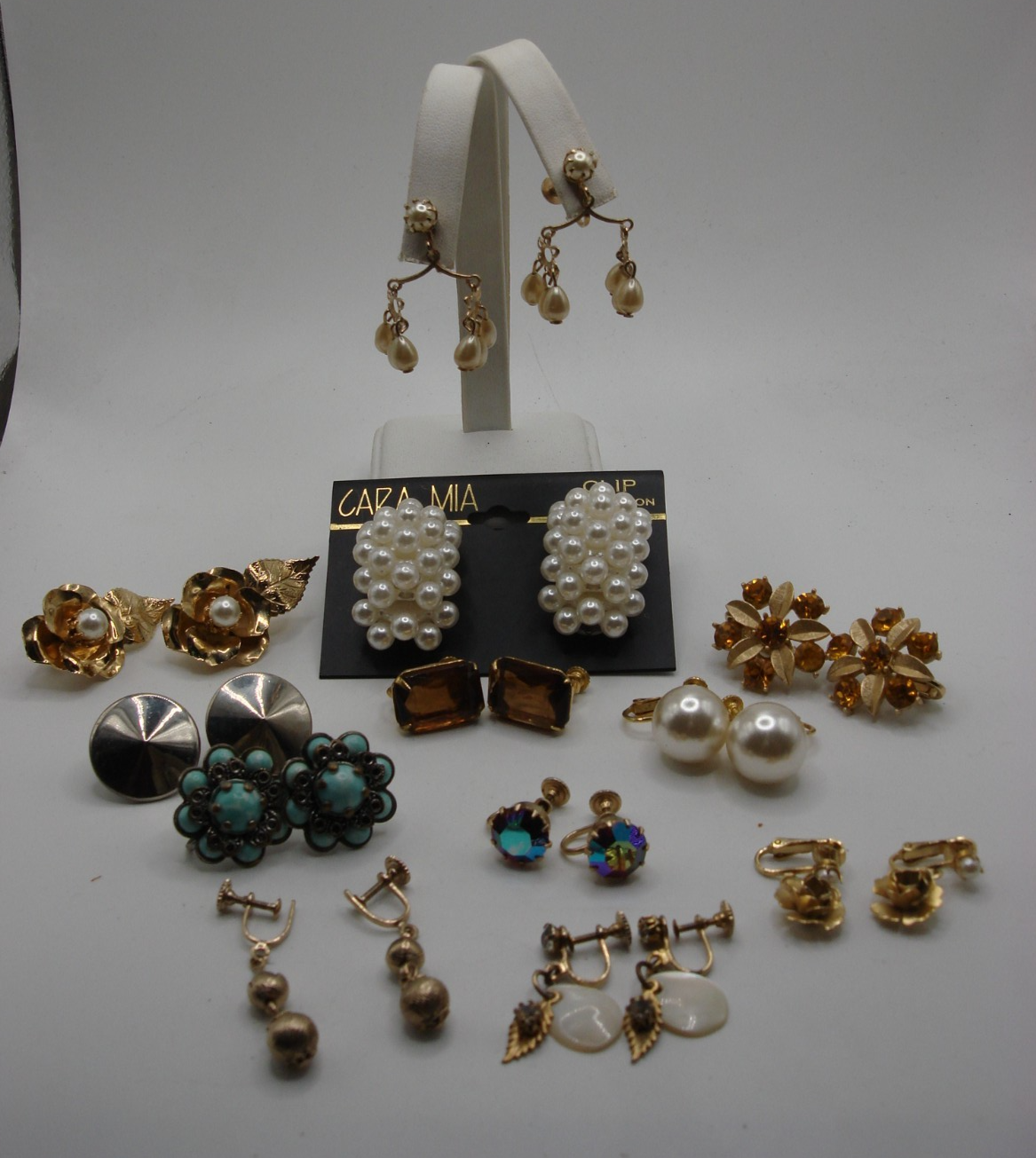 Vintage screw back and clip-on earrings set, featuring faux pearls, amber rhinestones, and more.