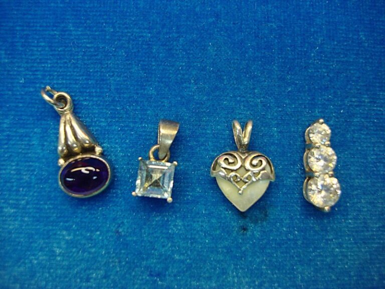 Set of four sterling silver gemstone pendants: amethyst, topaz, mother-of-pearl, and cubic zirconia