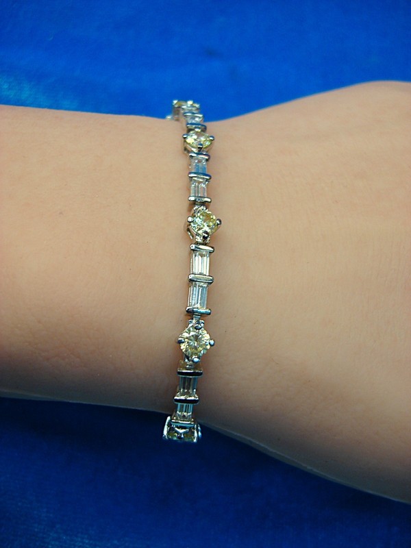 Sterling silver bracelet with citrine-colored cubic zirconia stones and baguette-cut CZs.