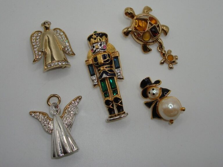 Collection of five vintage Monet pins featuring a soldier, angels, snowman, and more.