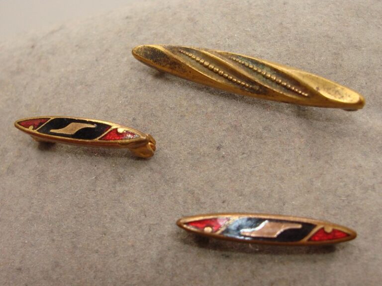 Set of three antique Victorian lingerie pins with enamel and gold tone designs
