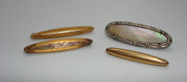 Set of four antique Victorian lingerie pins in silver, gold tone, and unique designs.