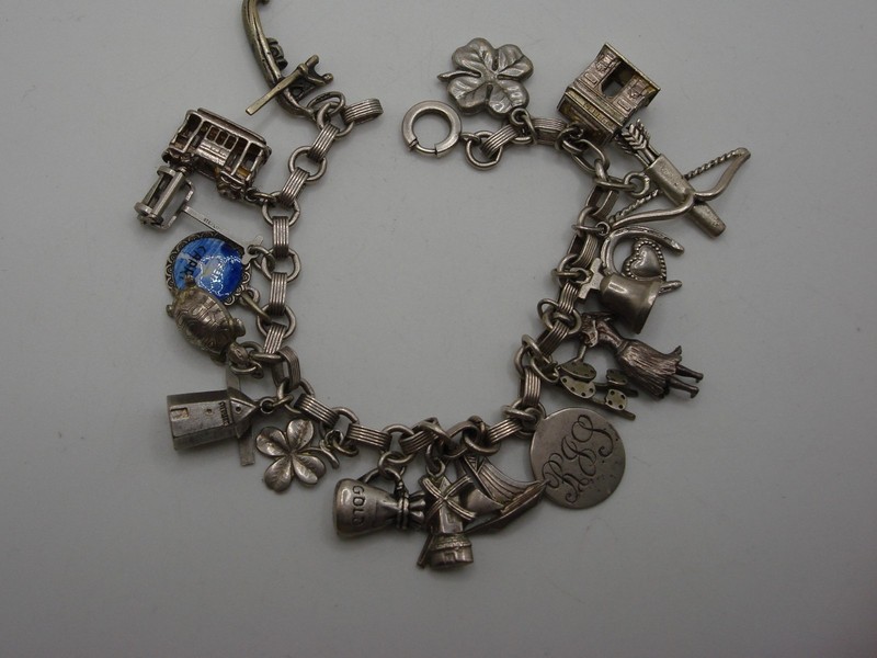 Vintage sterling silver charm bracelet with 18 unique travel-themed charms, including a San Francisco cable car and gondola.