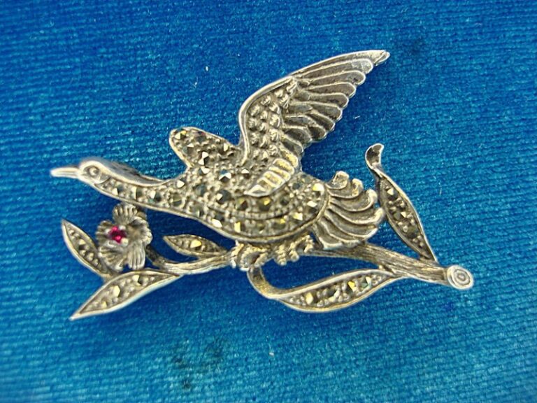 Vintage sterling silver flying bird pin with marcasites and red stone