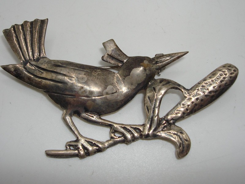 Vintage sterling silver crested bird pin on a branch