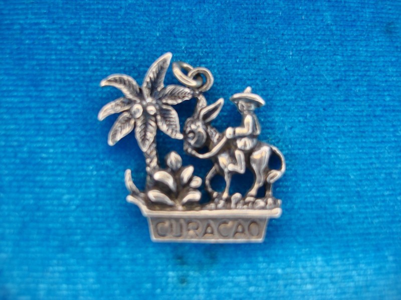 Vintage sterling silver Curacao charm featuring a gentleman riding a donkey.