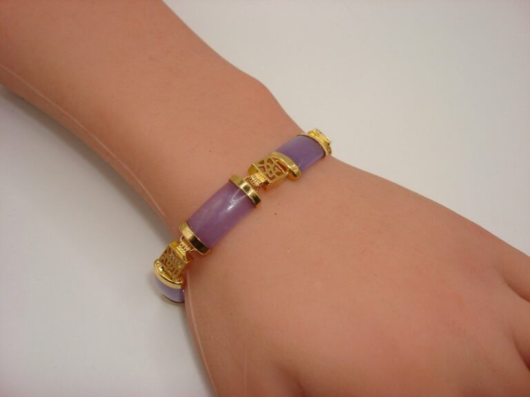Gold tone Chinese symbols jade bracelet with purple jade and filigree.