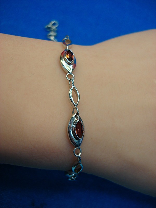 Sterling silver bracelet with five marquise cut red stones, adjustable 6-7.25 inches
