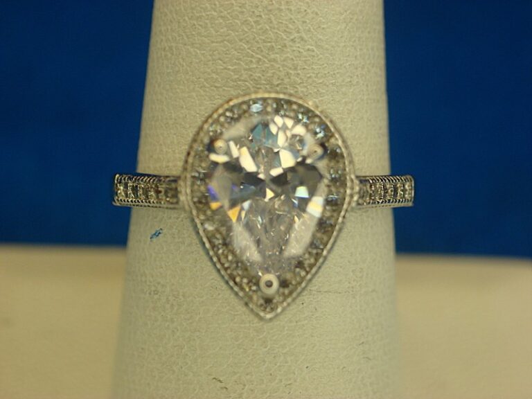 Sterling silver ring with pear-shaped gemstone and diamond simulants