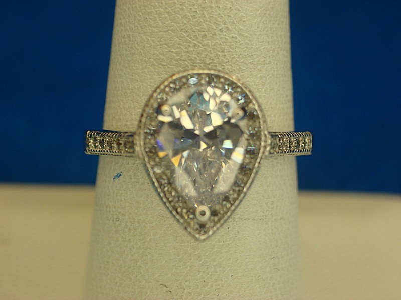 Sterling silver ring with pear-shaped gemstone and diamond simulants
