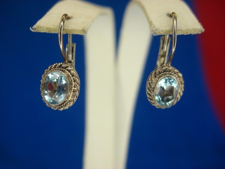 Sterling silver dangle earrings with light blue topaz gemstones