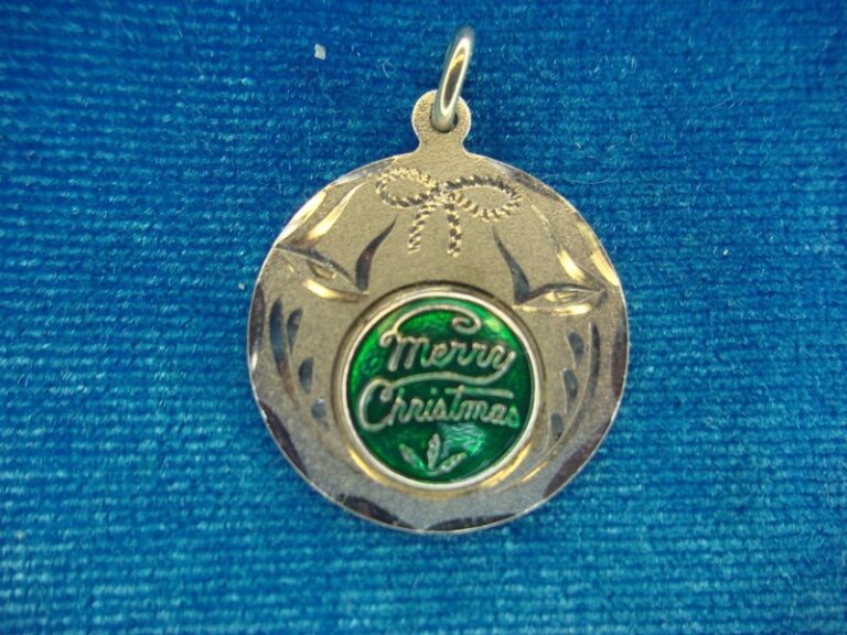 Vintage Spencer Co. Sterling Silver Merry Christmas Charm with diamond cut accents and green enamel inscription.