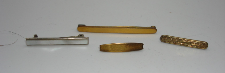 Set of four antique Art Nouveau-inspired lingerie pins, including three gold-tone Hayward pins and a silver pin with abalone inlay.