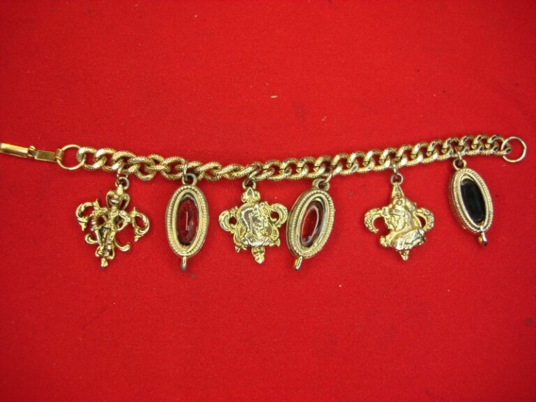 Vintage gold-tone charm bracelet with colorful stones, fleur de lis, and unique charms