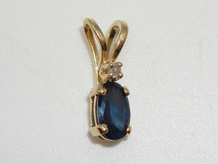 14K gold pendant with blue topaz and diamond accents