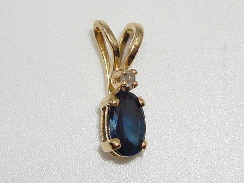 14K gold pendant with blue topaz and diamond accents