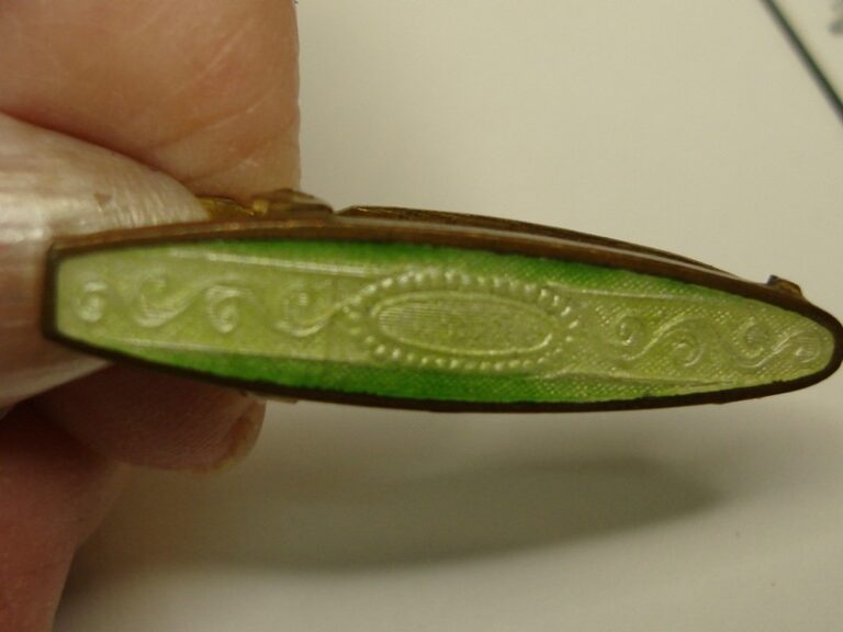 Antique Art Deco lingerie clip made of gold-washed brass and green guilloche enamel
