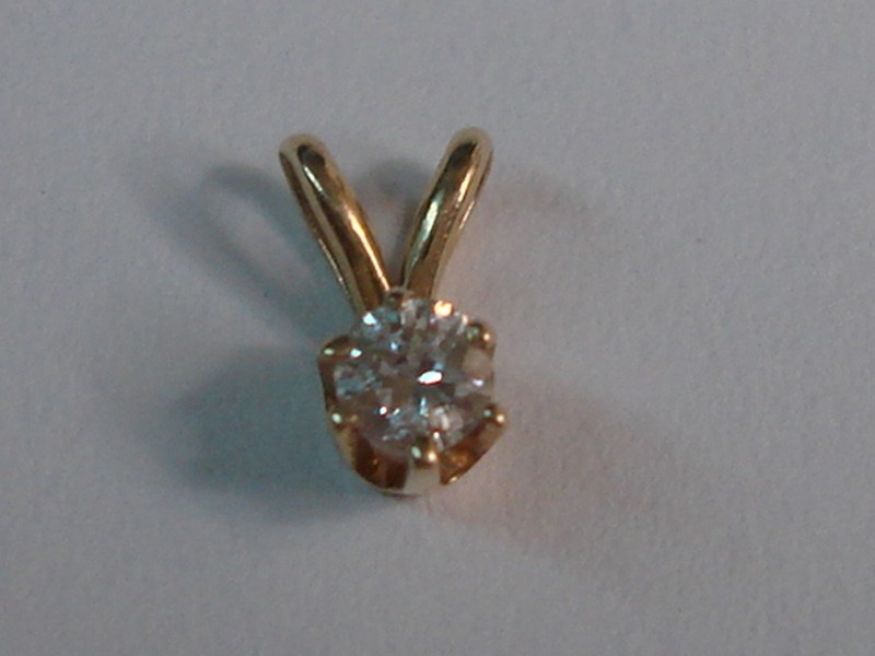 14K gold diamond pendant with a sparkling 0.05 carat diamond.