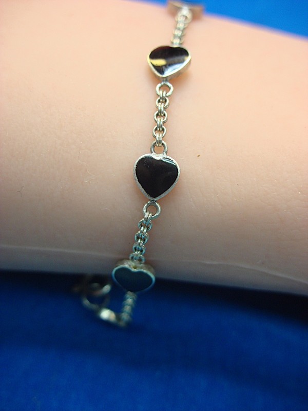 Sterling silver bracelet with ten onyx hearts