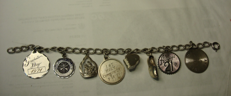 Vintage 1960s Monet silver charm bracelet with graduation, religious and birthday charms.