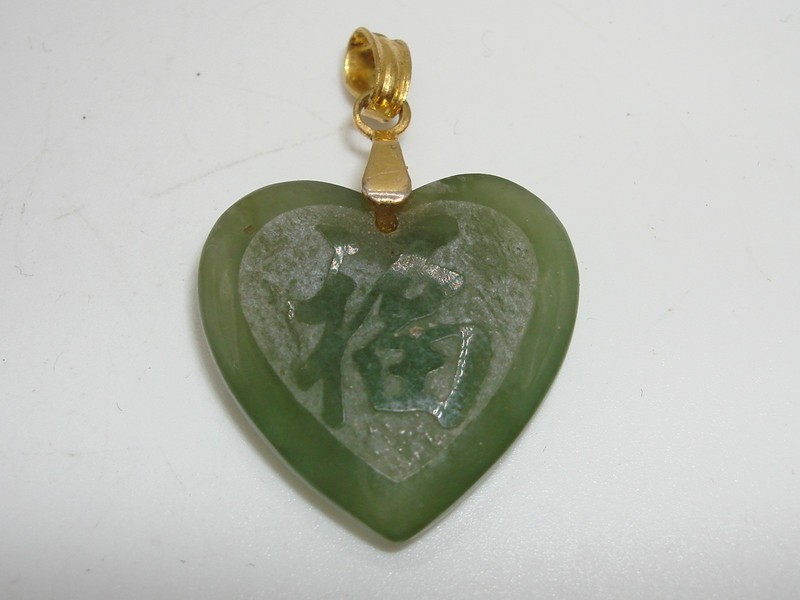 Vintage green jade heart pendant carved with a love symbol