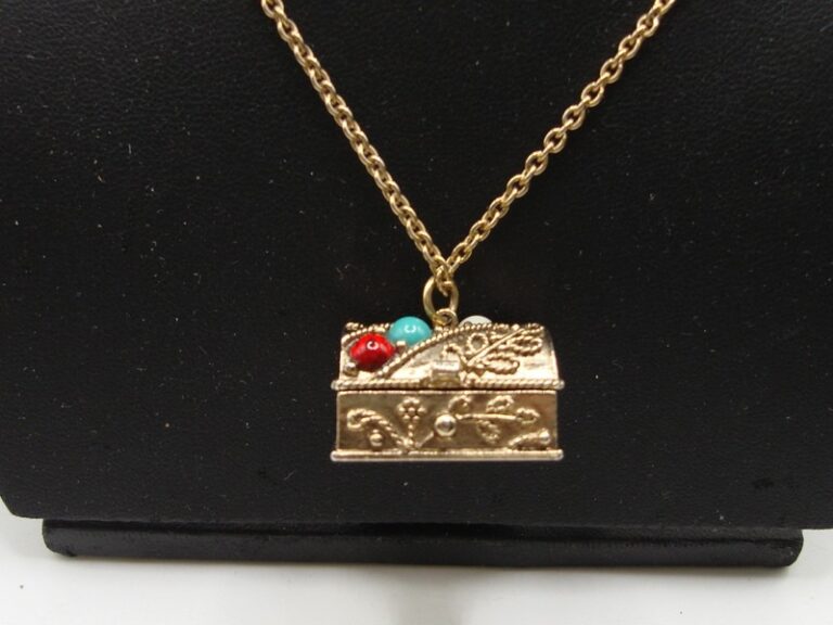 Vintage 1974 Avon gold tone treasure chest pendant necklace with filigree and faux gemstones