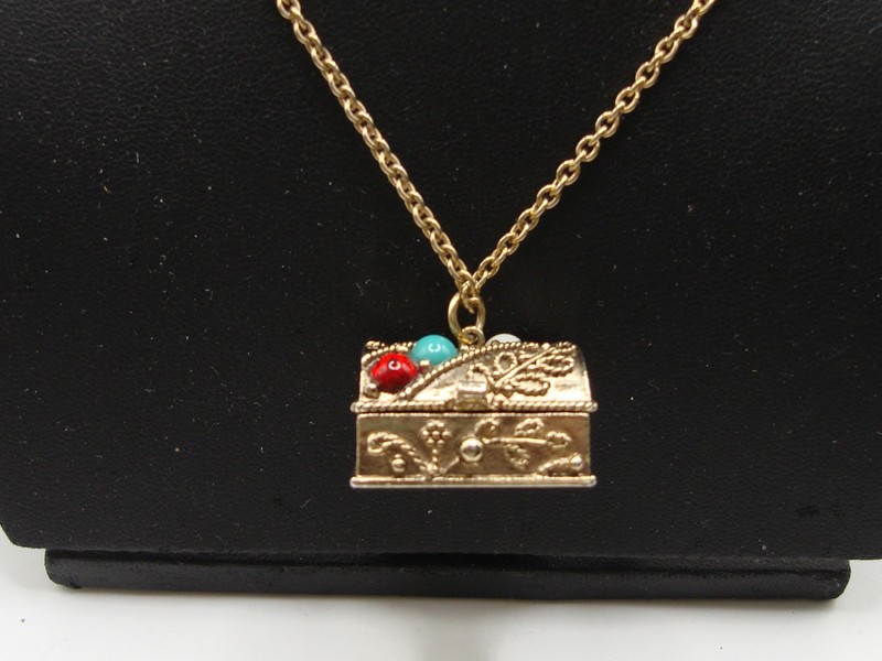 Vintage 1974 Avon gold tone treasure chest pendant necklace with filigree and faux gemstones