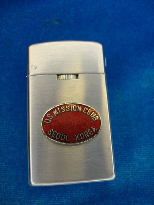 Vintage U.S. Mission Club Seoul Korea butane lighter with engraved map and badge