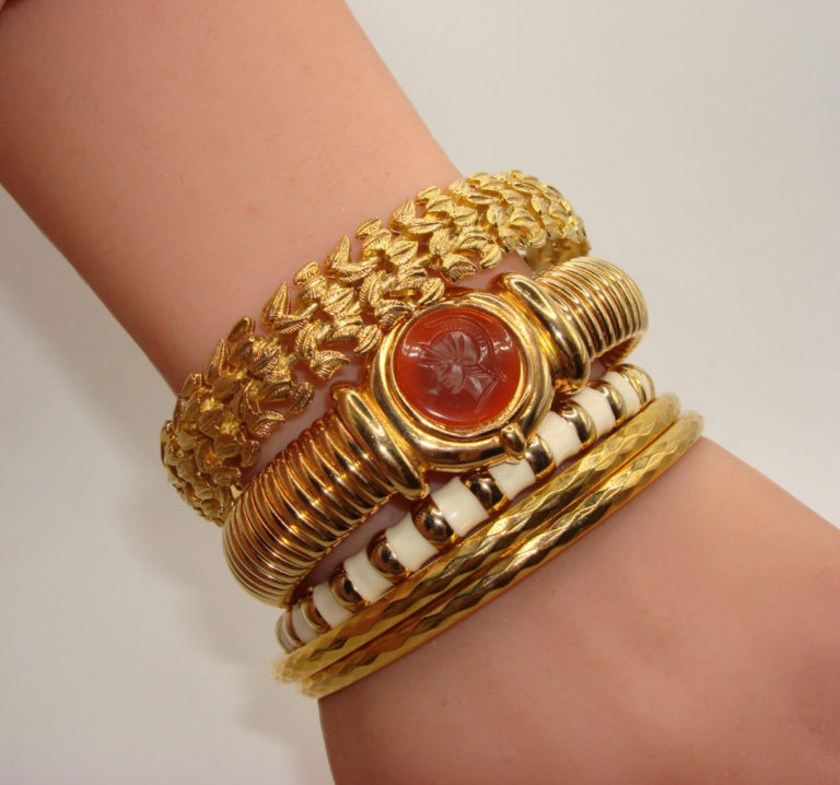 Set of 5 vintage gold-tone bracelets, including cuffs and bangles in excellent condition.