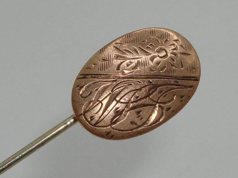 Antique Art Nouveau rose gold filled initial stick pin with floral design and 'WGJ' inscription.