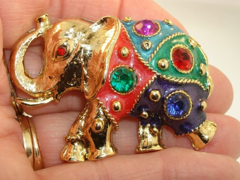 Vintage enamel and rhinestone elephant brooch pin in gold tone with red rhinestone eye and multicolor enamel