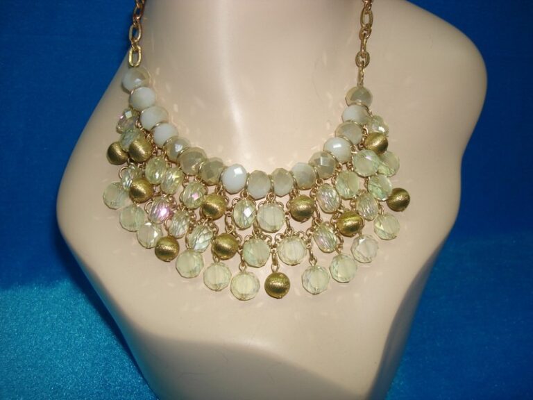 Gold tone and crystal bib necklace with faceted glass and dangle beads