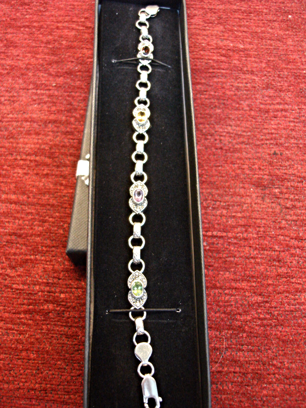 Sterling silver bracelet with amethyst, topaz, garnet, and peridot stones accented with marcasites.
