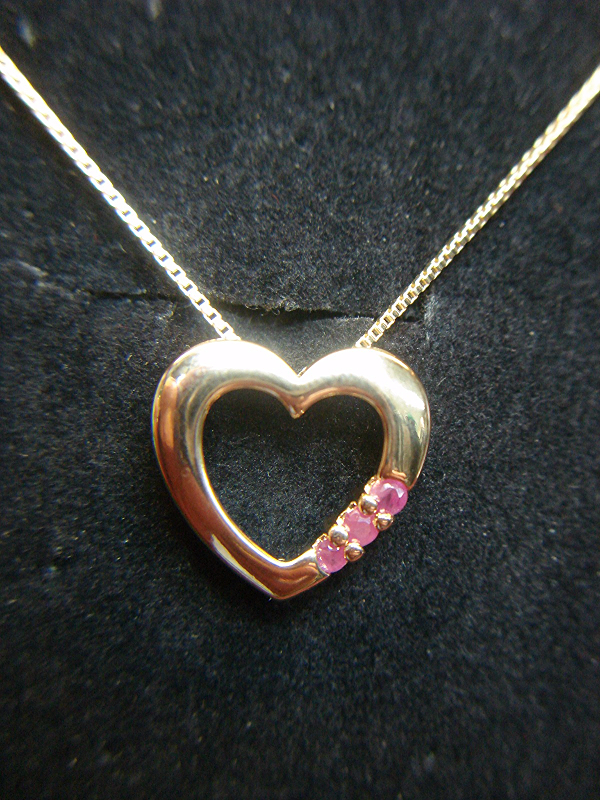 Sterling silver heart pendant with rose gold vermeil, rubies, and chain