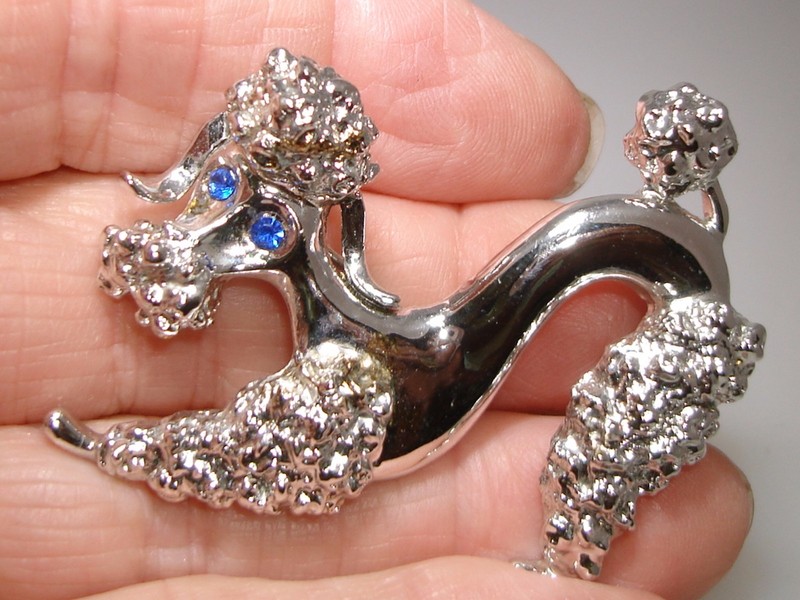 Vintage Gerry's curly poodle pin with blue rhinestone eyes
