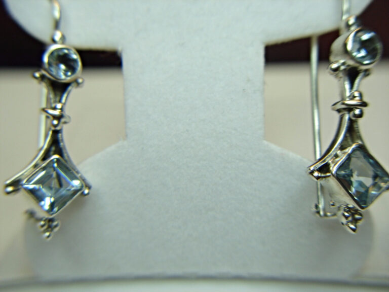 Sterling silver dangle earrings with blue topaz stones