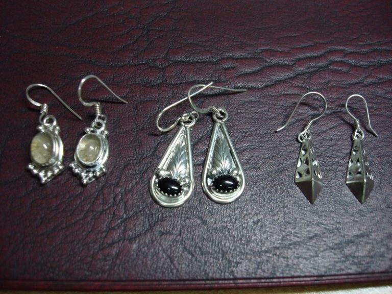 Three sets of sterling silver dangle earrings with onyx and stones
