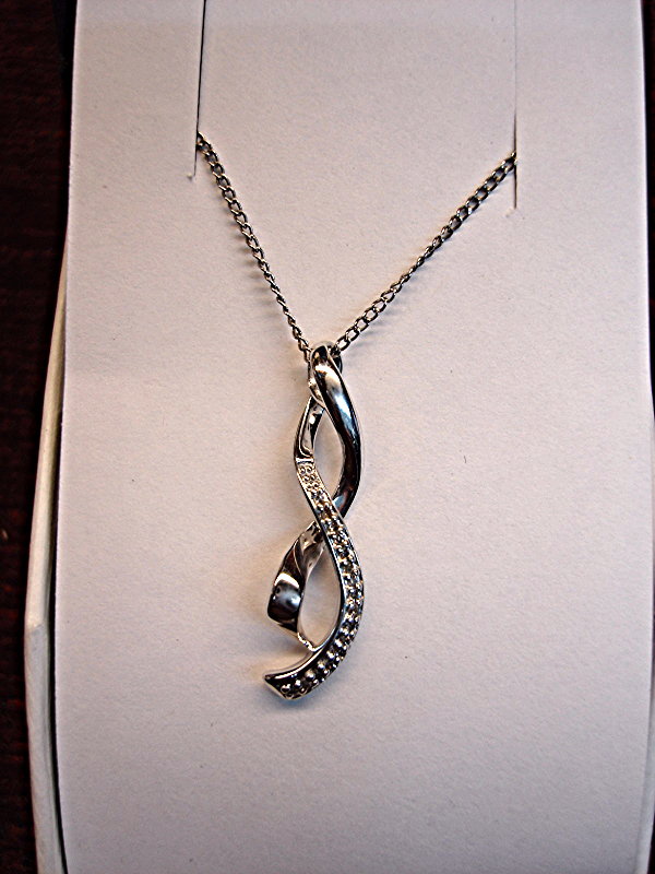 Sterling silver ribbon pendant with diamonds