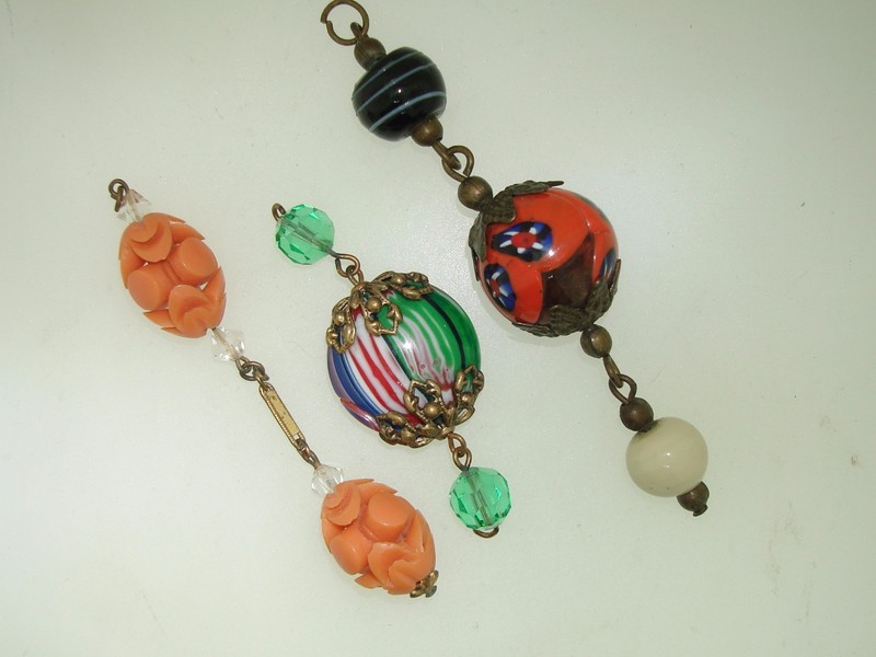 Three vintage jewelry sections featuring antique art glass and lucite beads