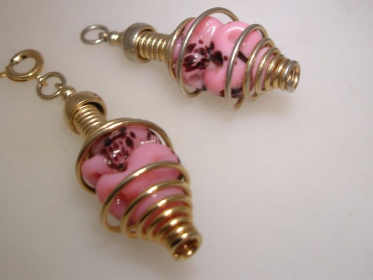 Pair of vintage pink art glass pendants with gold-tone spring settings
