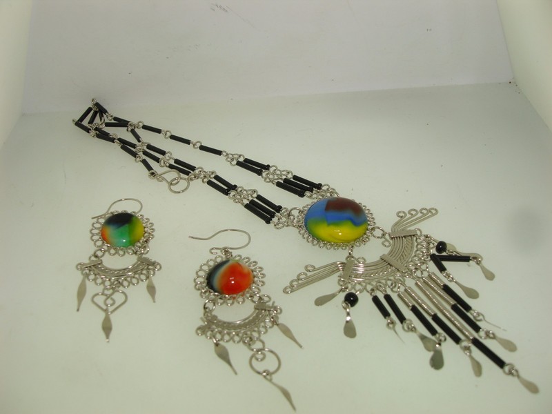 Artisan crafted silver necklace and dangle earrings set with hand-blown blue, red, and green glass cabochons