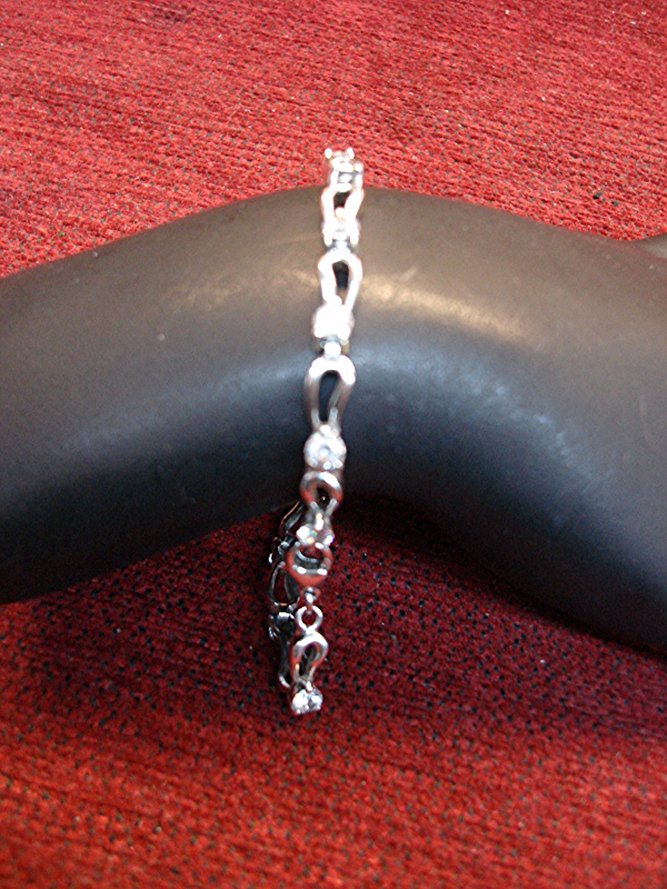 Sterling silver bracelet with cubic zirconia accents, unique design, 7.5 inches