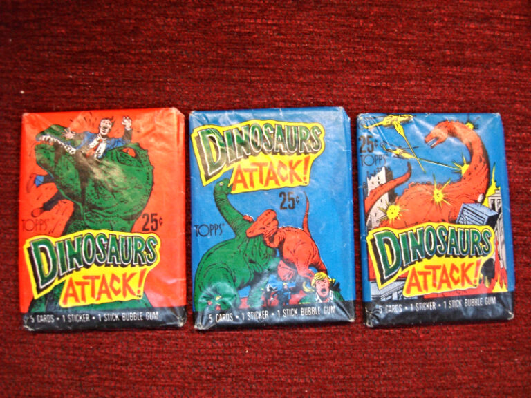 3 unopened packs of 1988 Topps Dinosaurs Attack trading cards, each with a unique cover design.