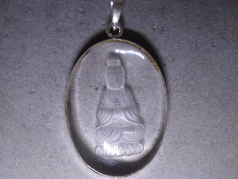 Sterling silver pendant with a reverse-carved crystal Buddha